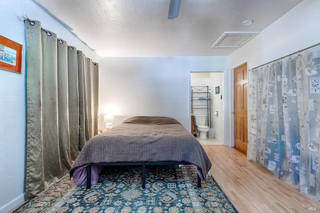5851 Vine Hill Rd, Sebastopol, CA 95472 - bedroom featuring light wood-style floors, ensuite bath, a ceiling fan, attic access, and baseboards