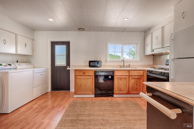 5851 Vine Hill Rd, Sebastopol, CA 95472 - kitchen with white appliances, washer and clothes dryer, a sink, light wood-type flooring, and light countertops