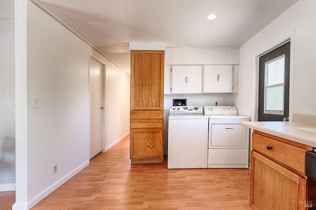 5851 Vine Hill Rd, Sebastopol, CA 95472 - washroom with washing machine and dryer, cabinet space, and light wood finished floors