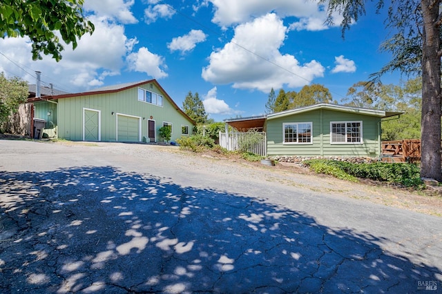 5851 Vine Hill Rd, Sebastopol, CA 95472 - view of front of house with driveway, board and batten siding, an outbuilding, and a detached garage