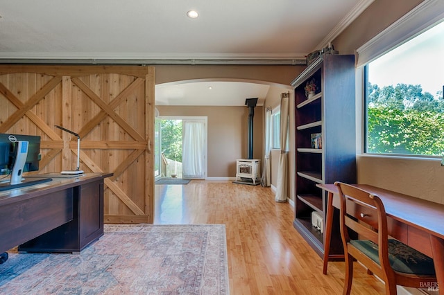 5851 Vine Hill Rd, Sebastopol, CA 95472 - office area with a wood stove, wood finished floors, arched walkways, crown molding, and baseboards