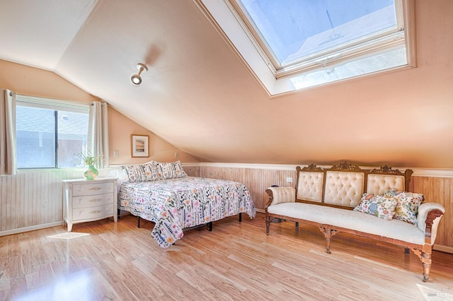 5851 Vine Hill Rd, Sebastopol, CA 95472 - bedroom featuring a skylight, lofted ceiling, wood finished floors, baseboards, and wooden walls