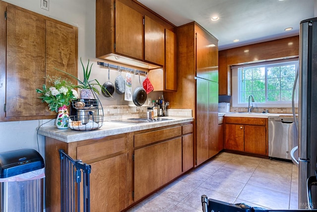 5851 Vine Hill Rd, Sebastopol, CA 95472 - kitchen with appliances with stainless steel finishes, brown cabinets, light countertops, backsplash, and a sink