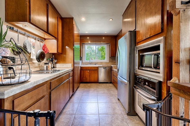 5851 Vine Hill Rd, Sebastopol, CA 95472 - kitchen featuring stainless steel appliances, light countertops, brown cabinets, a sink, and light tile patterned flooring