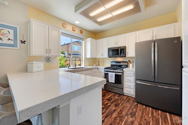 2775 Red Tail St, Santa Rosa, CA 95407 - kitchen featuring stainless steel appliances, a peninsula, white cabinets, dark wood finished floors, and a sink