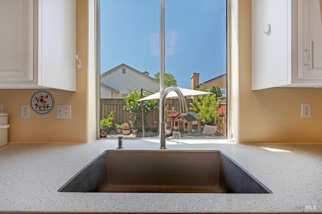 2775 Red Tail St, Santa Rosa, CA 95407 - kitchen view of a sink, white cabinets, and light stone counters