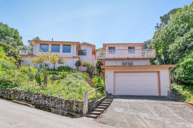 221 Tiburon Blvd, San Rafael, CA 94901 - view of front facade featuring a balcony, a garage, and stucco siding