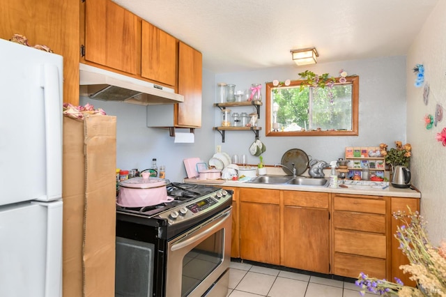 221 Tiburon Blvd, San Rafael, CA 94901 - kitchen featuring under cabinet range hood, freestanding refrigerator, stainless steel gas stove, a sink, and light countertops