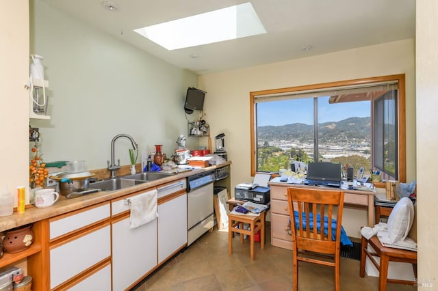 221 Tiburon Blvd, San Rafael, CA 94901 - kitchen with a sink, a skylight, white dishwasher, white cabinetry, and light countertops