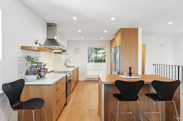 78 Marinero Cir, Tiburon, CA 94920 - kitchen featuring exhaust hood, stainless steel appliances, modern cabinets, a sink, and a kitchen bar