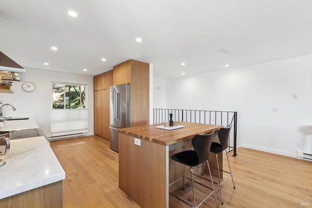 78 Marinero Cir, Tiburon, CA 94920 - kitchen featuring high end fridge, a baseboard heating unit, butcher block counters, light wood-style floors, and recessed lighting