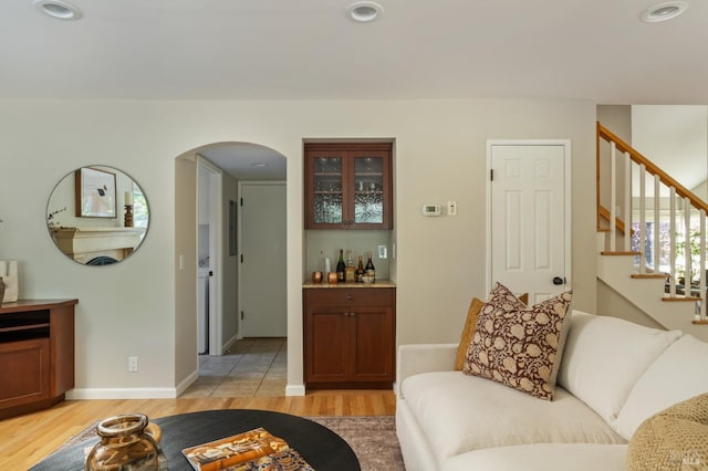 1263 Simmons Ln, Novato, CA 94945 - living area featuring light wood finished floors, arched walkways, recessed lighting, and stairway