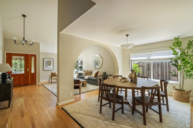 1263 Simmons Ln, Novato, CA 94945 - dining area featuring healthy amount of natural light, light wood finished floors, a chandelier, and baseboards