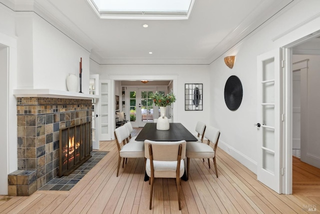 25 Winship Ave, Ross, CA 94957 - dining area with a tile fireplace, hardwood / wood-style flooring, recessed lighting, crown molding, and french doors