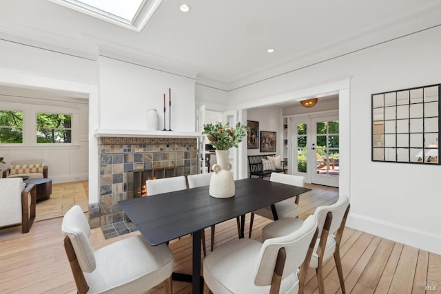 25 Winship Ave, Ross, CA 94957 - dining room with light wood-style flooring, french doors, a tile fireplace, plenty of natural light, and recessed lighting