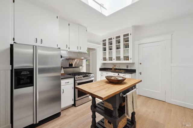 25 Winship Ave, Ross, CA 94957 - kitchen with stainless steel appliances, under cabinet range hood, dark countertops, and white cabinets