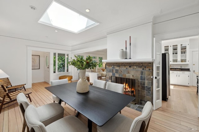 25 Winship Ave, Ross, CA 94957 - dining space featuring light wood finished floors, a fireplace, a skylight, and recessed lighting