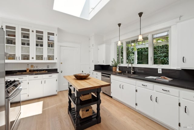 25 Winship Ave, Ross, CA 94957 - kitchen featuring stainless steel appliances, a sink, dark countertops, and light wood-type flooring