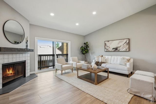 13 Freedom Ln S, Petaluma, CA 94952 - living area featuring a tile fireplace, recessed lighting, light wood finished floors, and vaulted ceiling