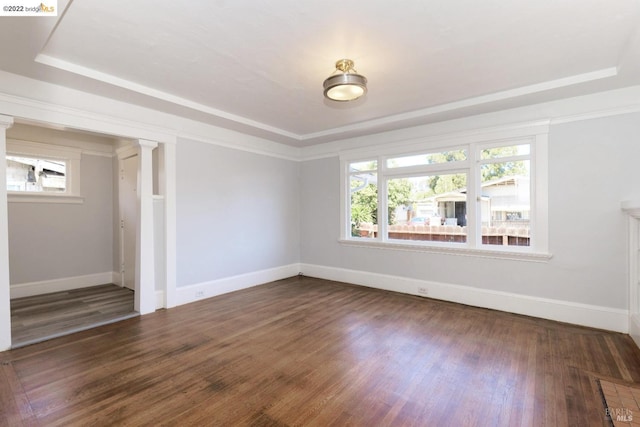 5817 Seminary Ct, Oakland, CA 94605 - unfurnished room with a raised ceiling, baseboards, dark wood-type flooring, and ornate columns