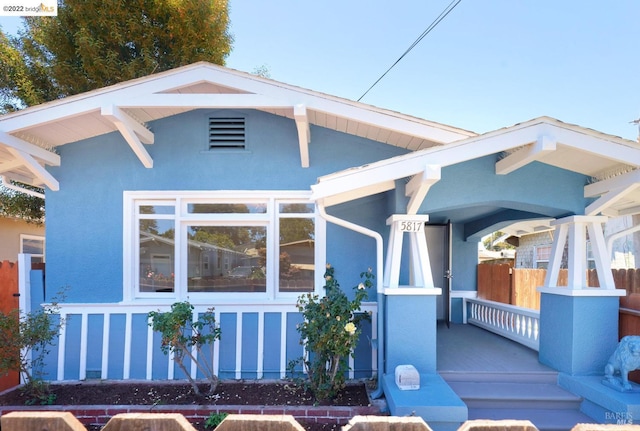 5817 Seminary Ct, Oakland, CA 94605 - view of front facade featuring a porch and stucco siding