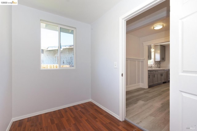 5817 Seminary Ct, Oakland, CA 94605 - empty room featuring dark wood finished floors, baseboards, and a sink