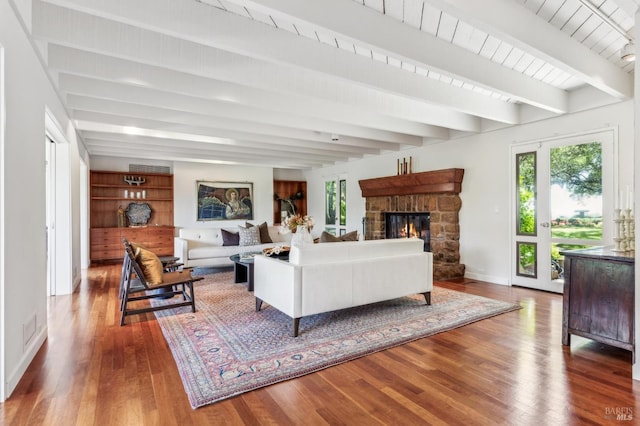 5768 Silverado Trl, Napa, CA 94558 - living room with wood finished floors, a stone fireplace, baseboards, and beam ceiling