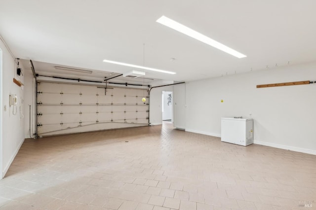 5768 Silverado Trl, Napa, CA 94558 - garage featuring baseboards and fridge