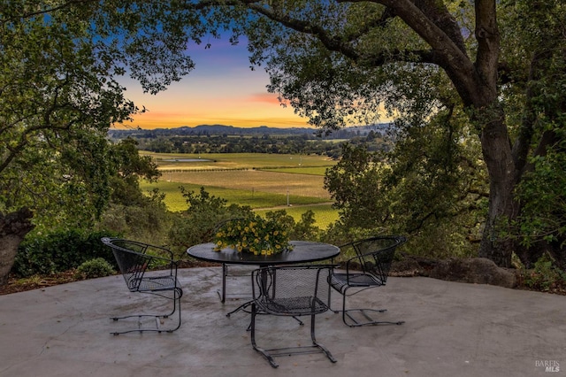 5768 Silverado Trl, Napa, CA 94558 - patio terrace at dusk with a patio area, outdoor dining space, and a rural view