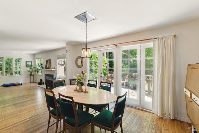 121 W Blithedale Ave, Mill Valley, CA 94941 - dining space with light wood finished floors, a fireplace, and french doors