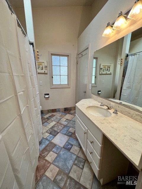 121 W Blithedale Ave, Mill Valley, CA 94941 - bathroom with vanity, stone finish flooring, and baseboards