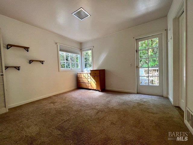 121 W Blithedale Ave, Mill Valley, CA 94941 - carpeted empty room with plenty of natural light and baseboards