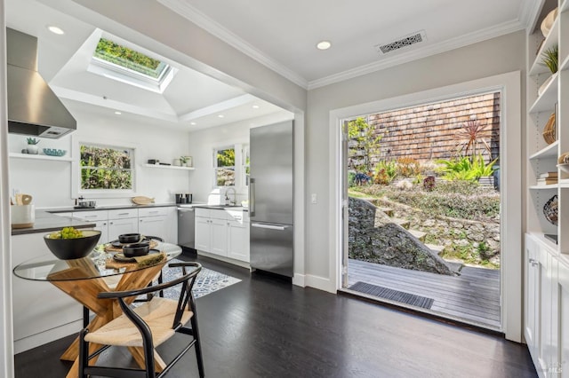 616 Locust St, Sausalito, CA 94965 - kitchen featuring open shelves, appliances with stainless steel finishes, wall chimney range hood, a skylight, and white cabinetry