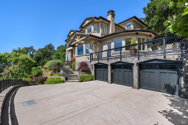 30 Sandy Ln, Mill Valley, CA 94941 - view of front of house with stairway, stucco siding, a balcony, concrete driveway, and stone siding