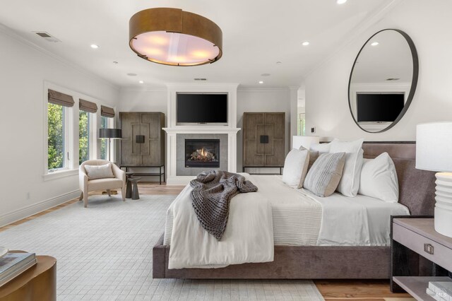 30 Sandy Ln, Mill Valley, CA 94941 - bedroom with crown molding, wood finished floors, recessed lighting, a warm lit fireplace, and baseboards