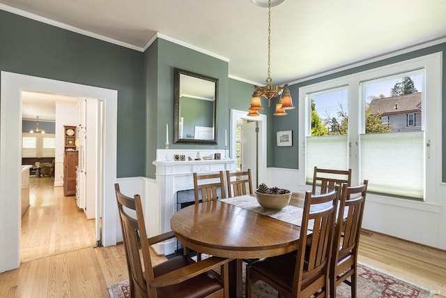 406 Franklin St, Napa, CA 94559 - dining area with a chandelier, light wood-type flooring, plenty of natural light, ornamental molding, and wainscoting