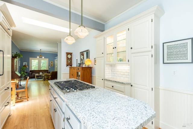406 Franklin St, Napa, CA 94559 - kitchen with stainless steel gas cooktop, light wood-style floors, light stone counters, glass insert cabinets, and pendant lighting