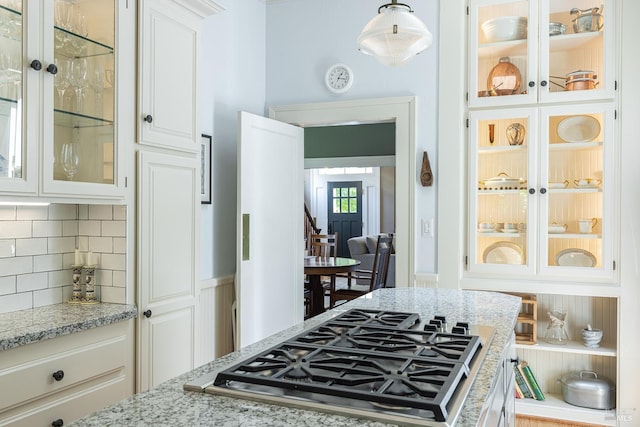 406 Franklin St, Napa, CA 94559 - kitchen featuring stainless steel gas stovetop, tasteful backsplash, light stone counters, white cabinets, and glass insert cabinets