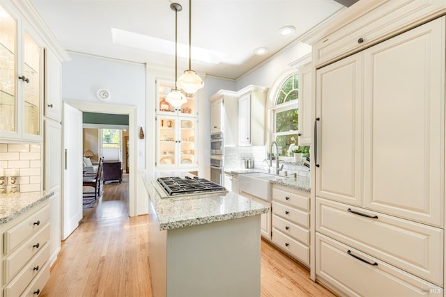 406 Franklin St, Napa, CA 94559 - kitchen with a sink, a center island, stainless steel appliances, light wood-type flooring, and backsplash