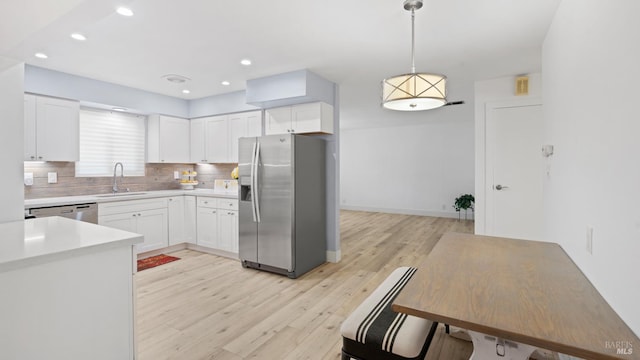 265 Chestnut St, Dixon, CA 95620 - kitchen featuring stainless steel appliances, a sink, light wood finished floors, light countertops, and white cabinetry