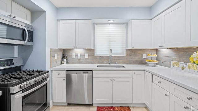 265 Chestnut St, Dixon, CA 95620 - kitchen with stainless steel appliances, a sink, tasteful backsplash, and white cabinets