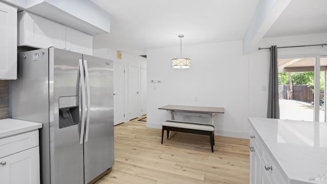 265 Chestnut St, Dixon, CA 95620 - kitchen featuring stainless steel fridge, white cabinets, light wood-style floors, decorative light fixtures, and beamed ceiling