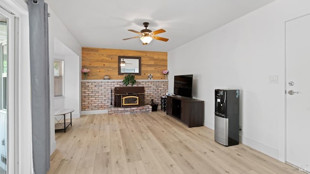 265 Chestnut St, Dixon, CA 95620 - unfurnished living room with wood walls, a ceiling fan, light wood-style flooring, an accent wall, and baseboards