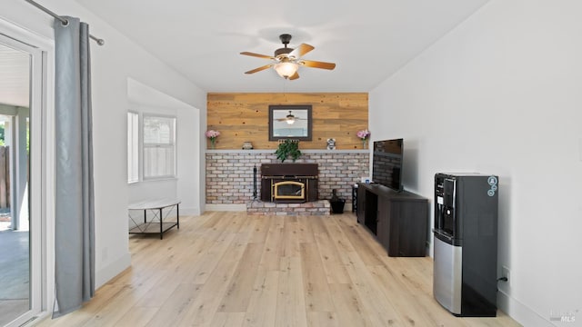 265 Chestnut St, Dixon, CA 95620 - living area with healthy amount of natural light, wood walls, a ceiling fan, an accent wall, and light wood-type flooring
