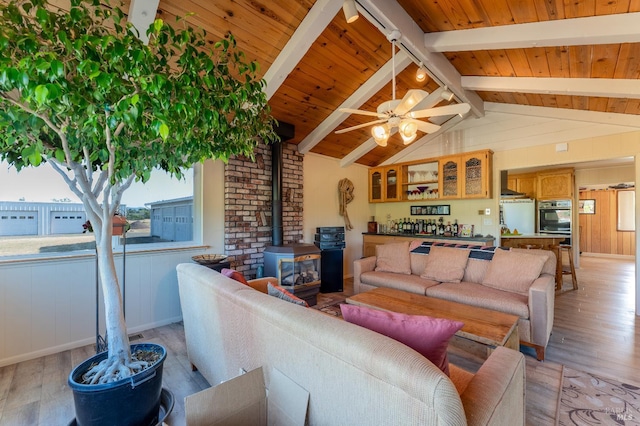 1961 Foothill Dr, Redwood Valley, CA 95470 - living room with light wood-style flooring, a wood stove, wood ceiling, ceiling fan, and bar