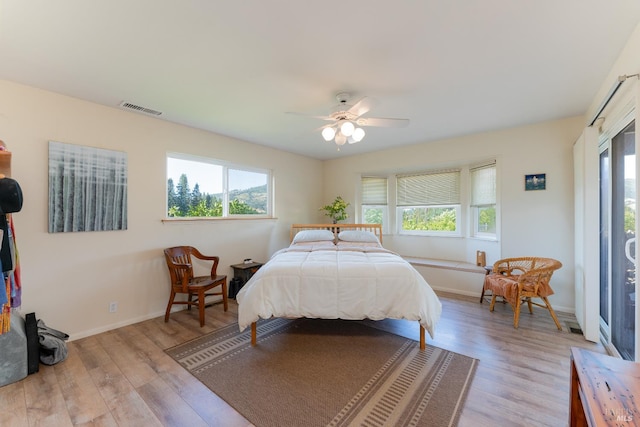 1961 Foothill Dr, Redwood Valley, CA 95470 - bedroom featuring multiple windows, light wood-style flooring, and baseboards