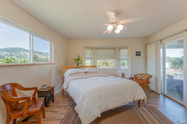 1961 Foothill Dr, Redwood Valley, CA 95470 - bedroom featuring access to exterior, light wood-style floors, a ceiling fan, and baseboards