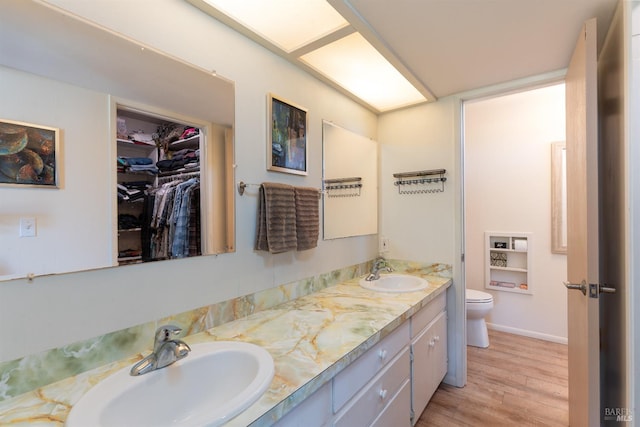 1961 Foothill Dr, Redwood Valley, CA 95470 - full bathroom featuring wood finished floors, double vanity, toilet, and a spacious closet