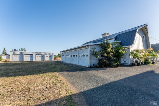 1961 Foothill Dr, Redwood Valley, CA 95470 - view of side of home with a standing seam roof, metal roof, community garages, and a lawn
