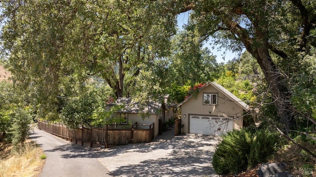 260 Geysers Rd, Cloverdale, CA 95425 - obstructed view of property with stucco siding, a detached garage, and driveway